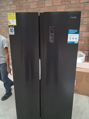 Nevecón Mabe Side by Side 480L / Black Steel — Hendidura / rayón leve con muesca en la parte inferior del panel frontal.